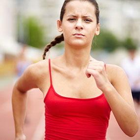 Young female runner participating in the race